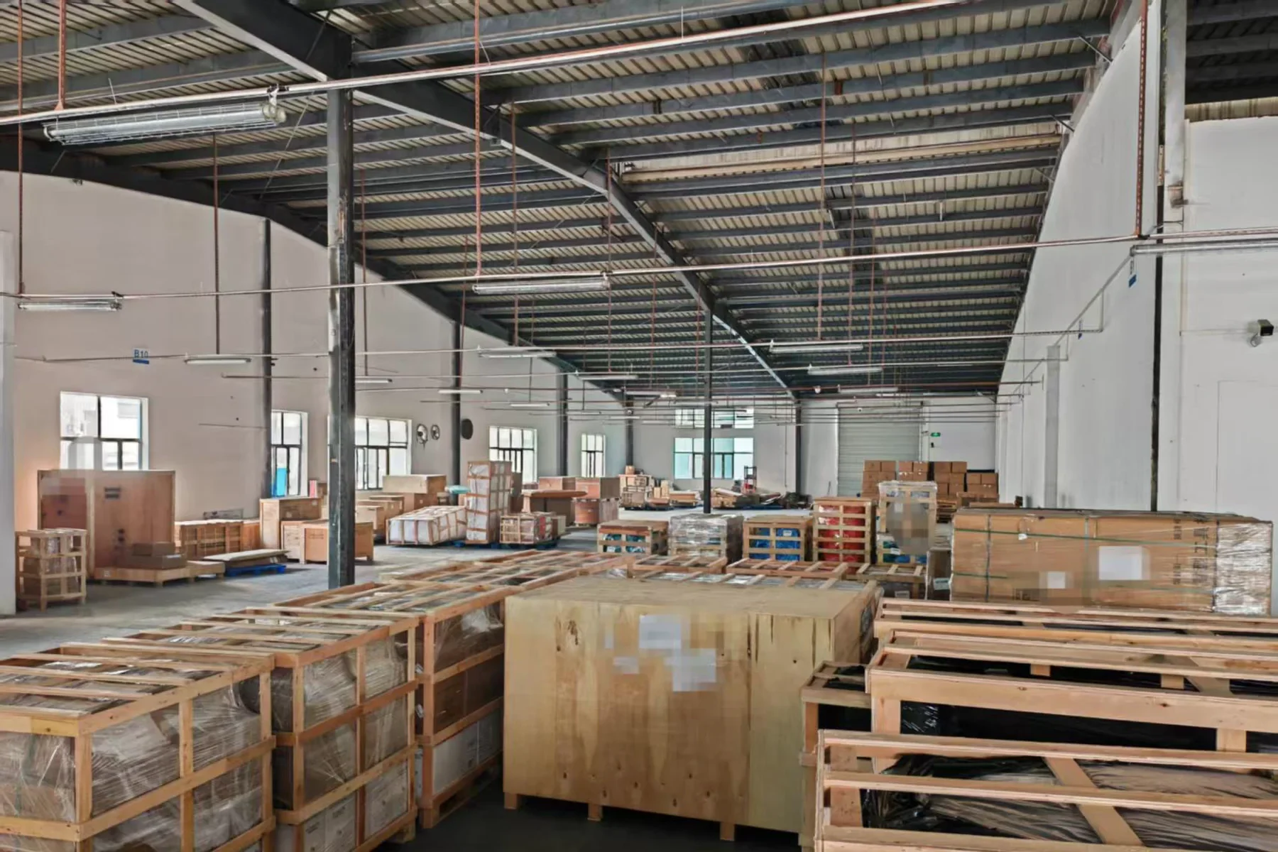 Large crated goods staged inside a China export warehouse
